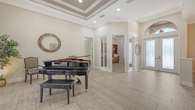 Living room with the executive office through the glass French doors