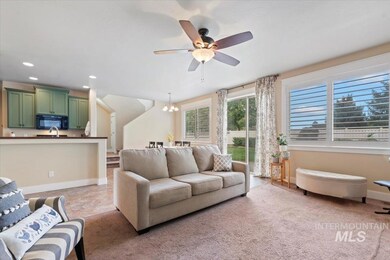 Living area featuring a chandelier, ceiling fan, and recessed lighting