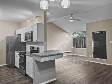 Kitchen featuring white cabinetry, a breakfast bar