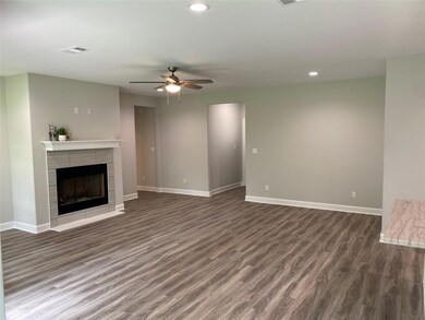 Unfurnished living room featuring ceiling fan, dar