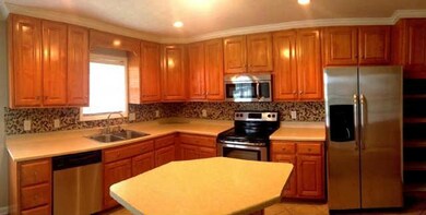 Great, open kitchen. Stainless steel appliances. Tile back splash. 