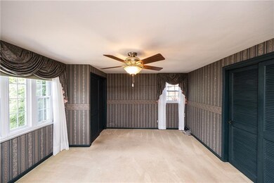 Master bedroom has his and her closets, neutral ca