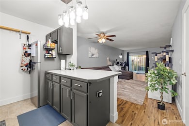 Step inside to a welcoming kitchen at the entry, complete with a peninsula-style island that offers both seating and workspace. From the kitchen, you’ll enjoy a direct view of the open-concept main level living area, creating the perfect flow for cooking, dining, and entertaining.