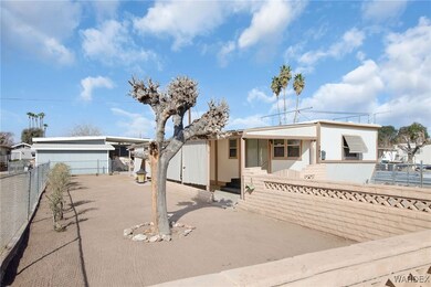 View of front of house featuring stucco siding and fence private yard