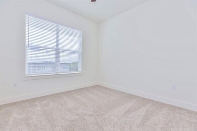 Spacious primary bedroom with direct access to bat