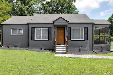 Bungalow-style house with a front lawn, stucco sid