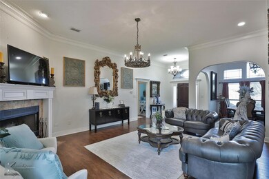 Living room featuring ornamental molding, a tiled 