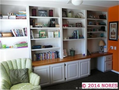Entire wall of built-in bookcases and desk in livi