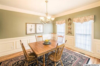 The dining room is located off the kitchen and has new wood floors, and exquisite molding.