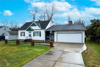 View of front facade with a garage and a front yard