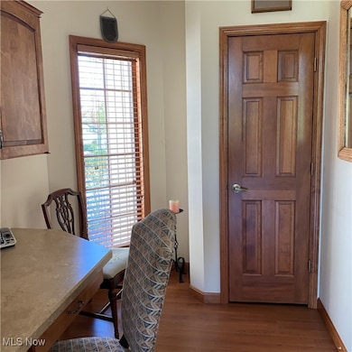 Office space featuring baseboards and dark wood-style floors.  Can also be used as coffee bar.