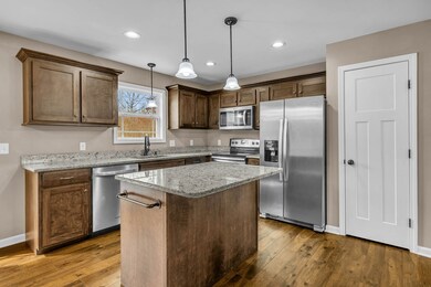 Enhanced by recessed lighting, the dark stained custom cabinets add a touch of timeless elegance to the room's aesthetic. 418 N Ballard Rd  Manchester, TN 37355