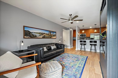 Living area with baseboards, a ceiling fan, reces