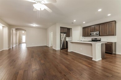 Kitchen with dark wood-type flooring, dark brown c