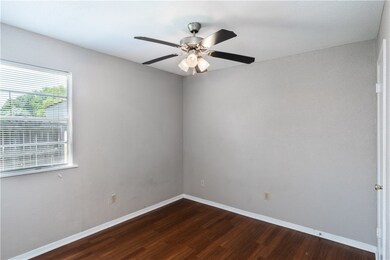 Spare room featuring baseboards, ceiling fan, and
