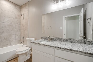 Bathroom with shower / bathtub combination and vanity