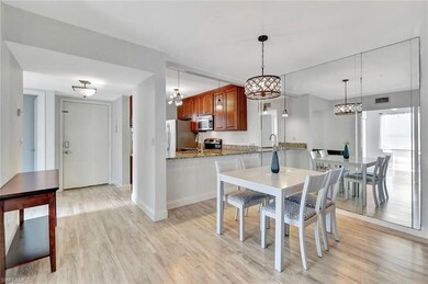 Dining area with a chandelier, light wood finished floors, and baseboards