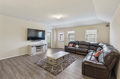Gather the family and guests together in your lovely living room! Featuring high ceilings, custom paint, gorgeous floors, and large windows that provide plenty of natural lighting throughout the day.