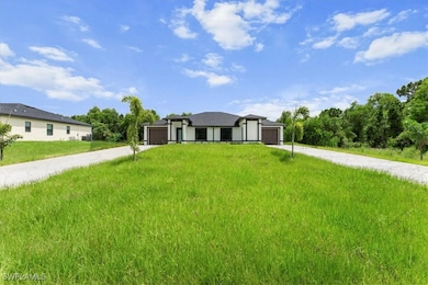 View of front of property with driveway, a garage,