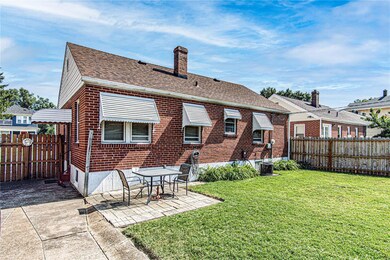 showing well manicured backyard with wooden fence