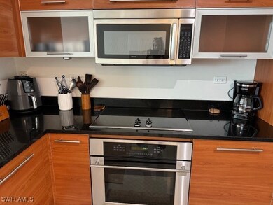 Kitchen featuring dark stone countertops and stain