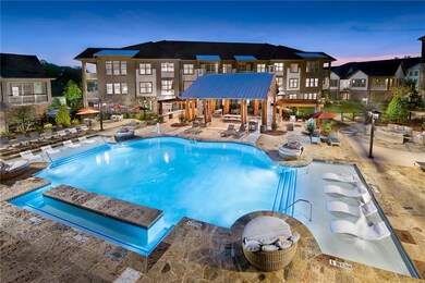 Pool at dusk featuring a patio area and pool water