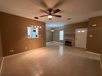 Unfurnished living room with ceiling fan, baseboa