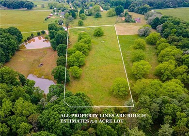 Drone / aerial view with a water view and a rural 
