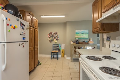 Kitchen featuring white appliances, under cabinet
