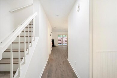 Hall featuring stairway and wood finished floors