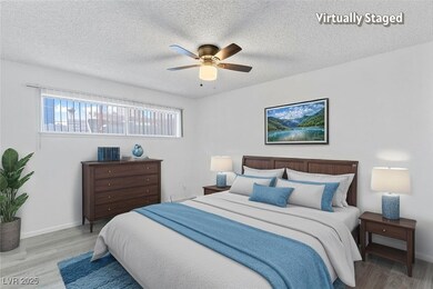 Bedroom with wood finished floors, a ceiling fan,