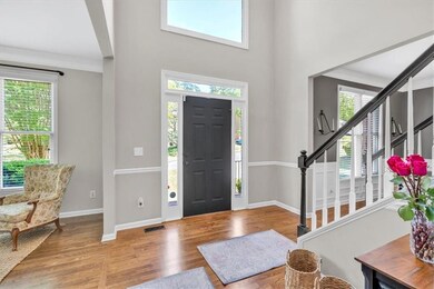 Foyer entrance featuring stairway, ornamental mold