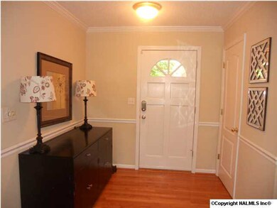 Welcome your guests in the large foyer with hardwood floors, crown molding and a chair rail.