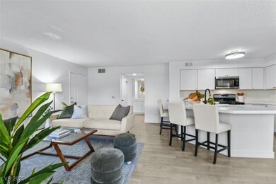Living area with visible vents, a textured ceiling