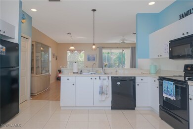 Kitchen featuring decorative light fixtures, black