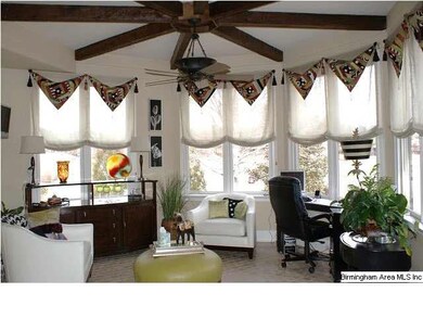 Light filled Keeping Room features beamed ceilings