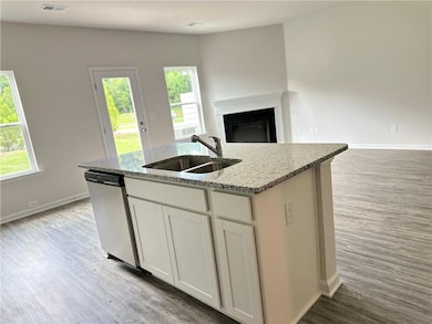 Kitchen featuring stainless steel dishwasher, open