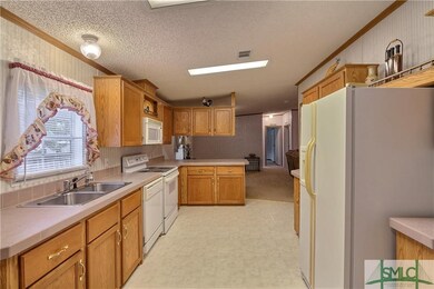 Kitchen with lots of cabinets and counter-tops.