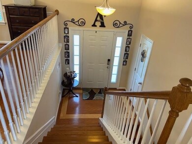 The Hardwood staircase looking down from the living room to the Foyer.
