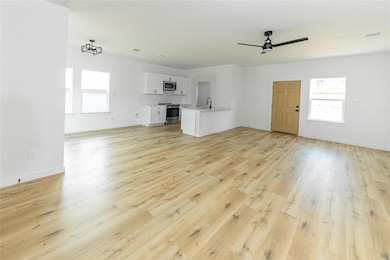 Unfurnished living room with a wealth of natural l
