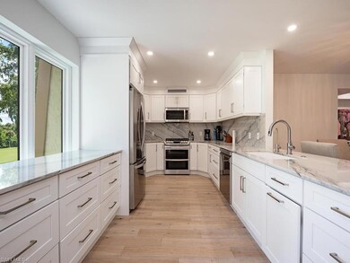 Kitchen featuring sink, white cabinetry, appliance