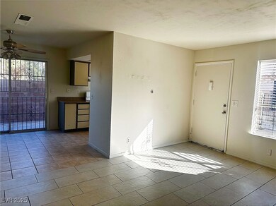 Unfurnished room featuring visible vents, baseboar