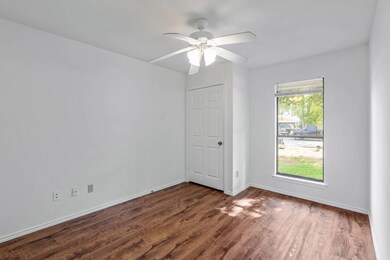 Spare room featuring dark wood-style flooring and ceiling fan