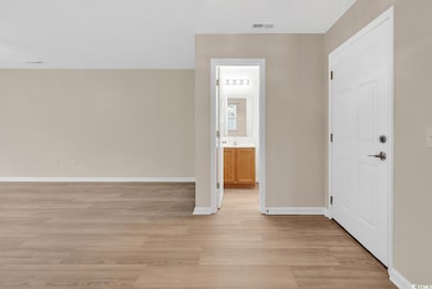 Empty room with light wood-style flooring and base