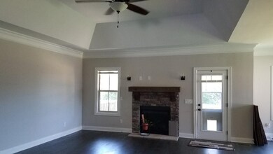 Stacked stone fireplace and vaulted ceiling with one of many fans in the living room.  Separate bonus room, too!