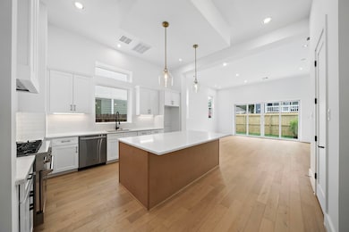 Gorgeous island kitchen with quartz counters, stai