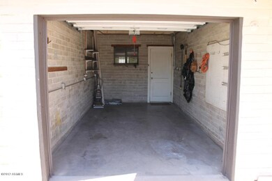 Garage leads into laundry/storage area