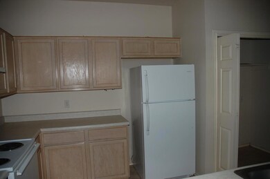 Kitchen featuring white appliances, light brown c