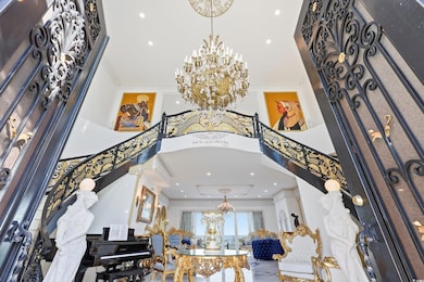 Entrance foyer featuring a chandelier, crown molding, recessed lighting, and a high ceiling
