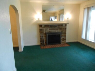 The inviting living room features a wood burning f